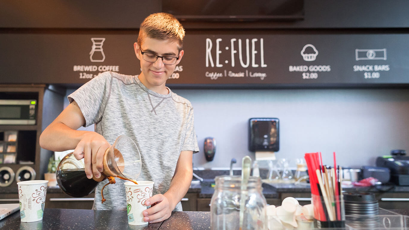 Students at Zeeland charter school open coffee shop iCademy Global