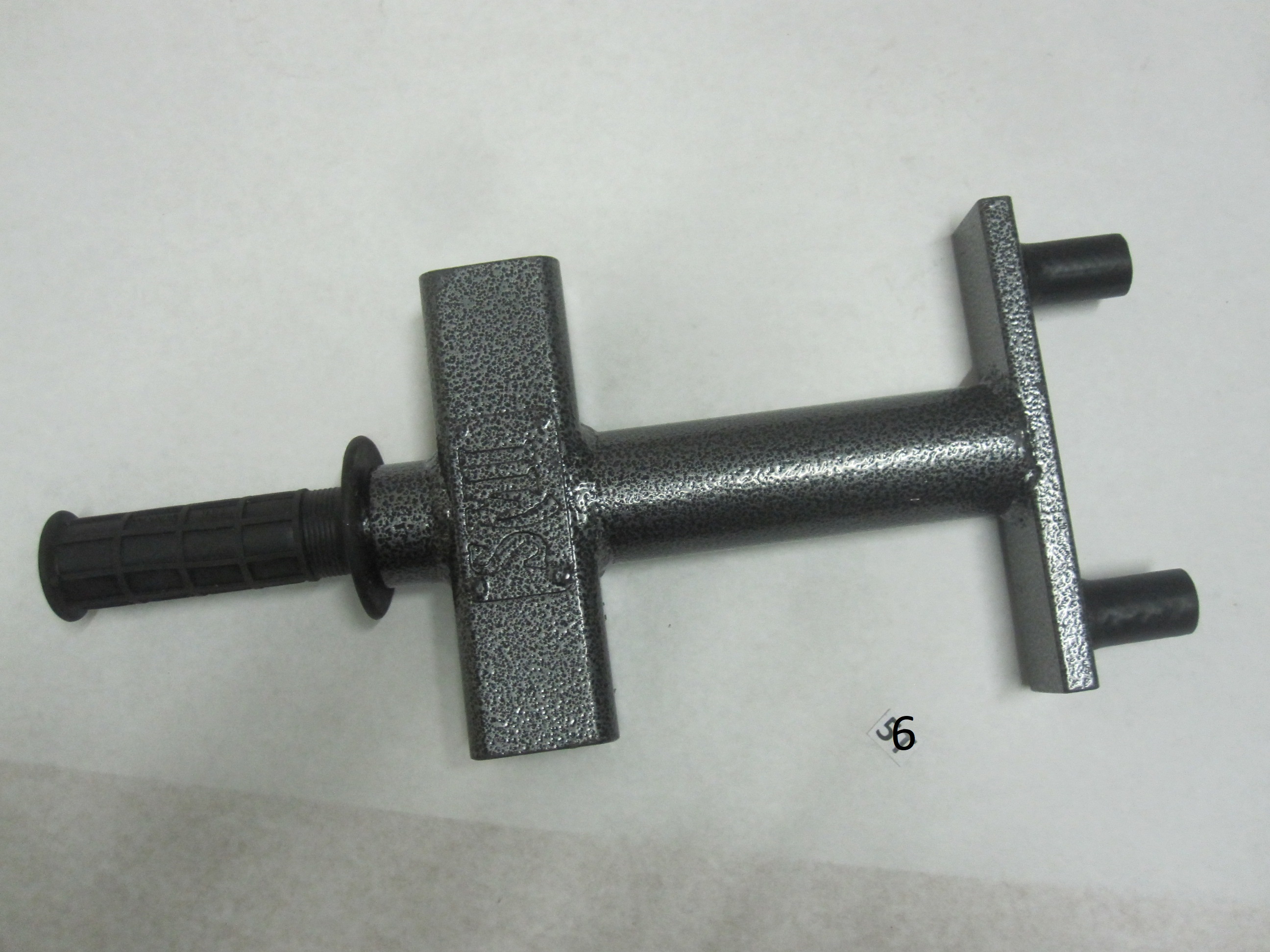 That is a tool to remove wire wheel knock offs, commonly found on