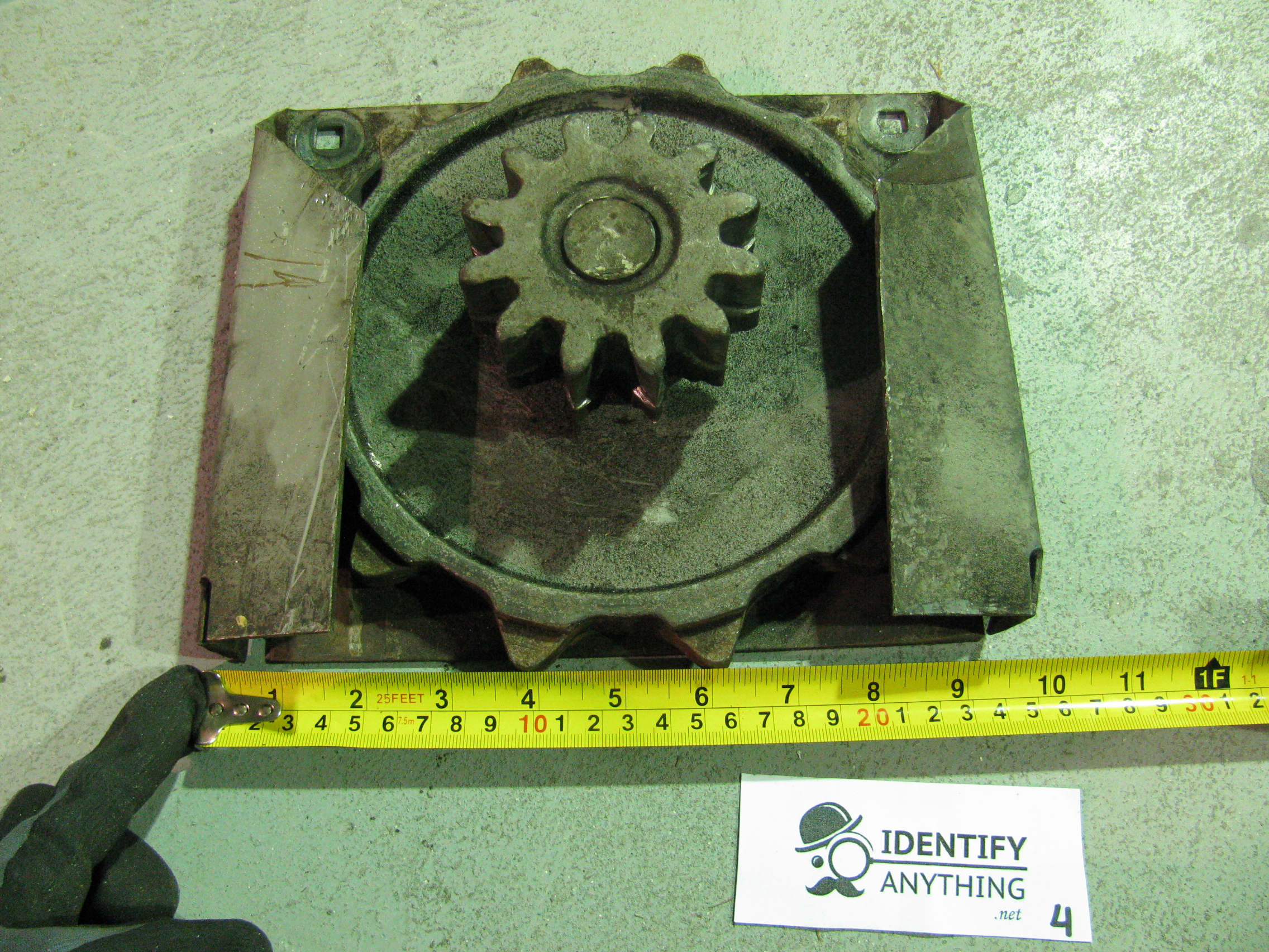 This is part of a very old hand operated chain hoist for a rollup