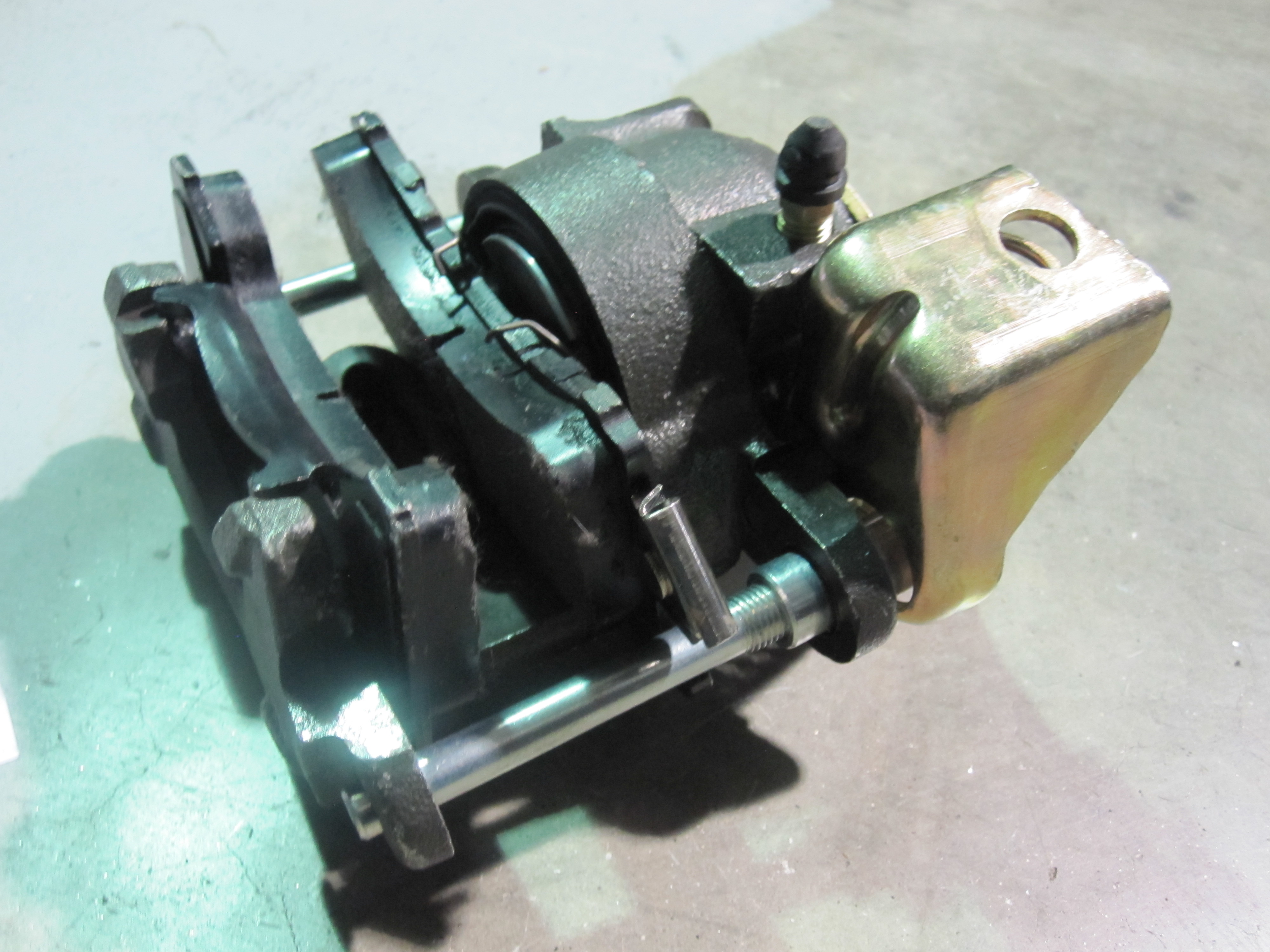 It's a REAR BRAKE CALIPER for a car with disc brakes. A rear caliper