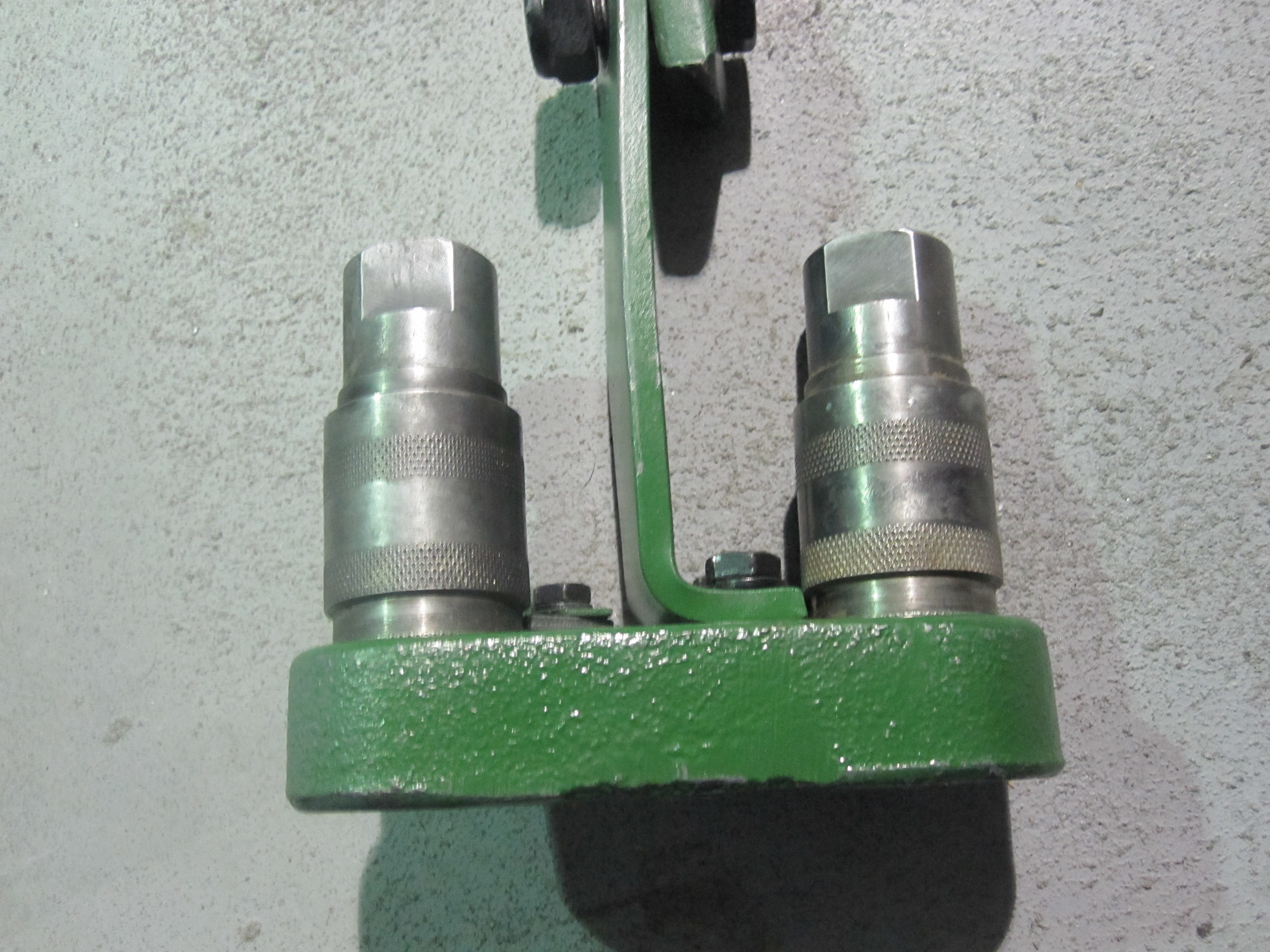 John Deere hydraulic remote bracket with female connectors. Used to