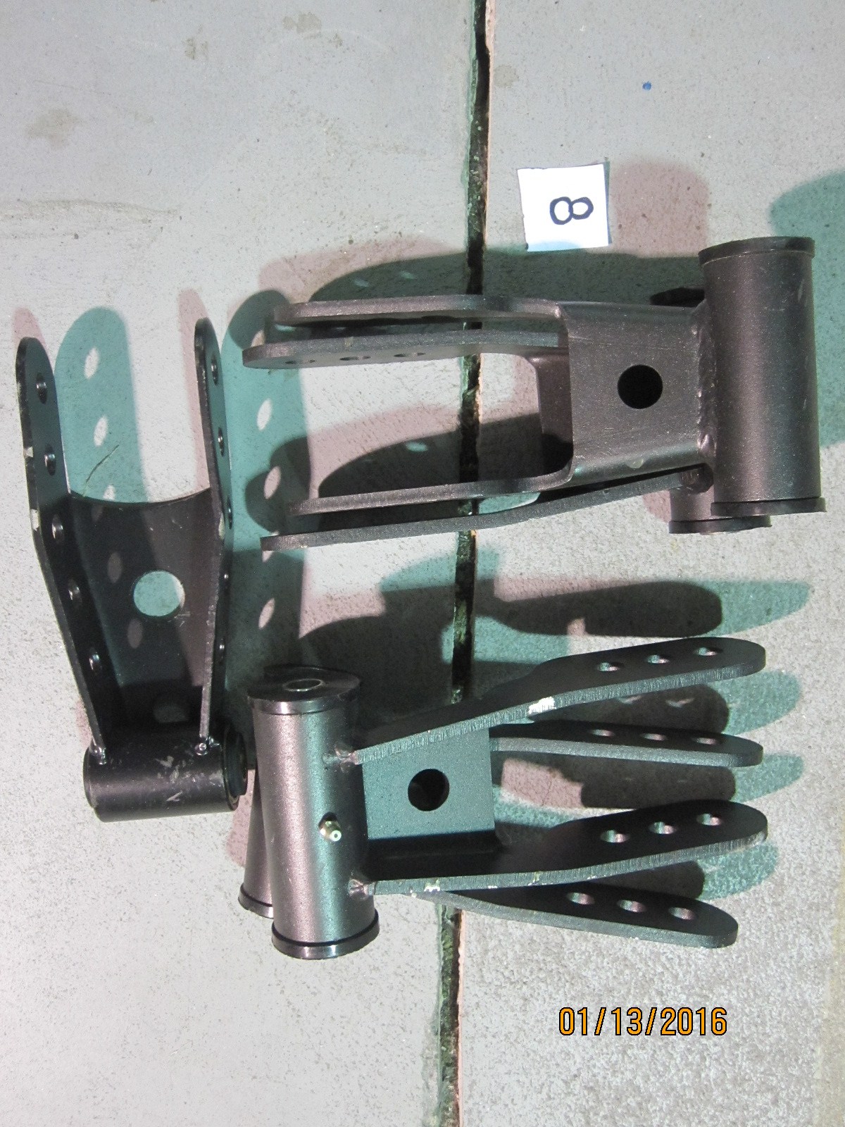 Adjustable drop shackles for rear leaf springs of GM trucks, probably