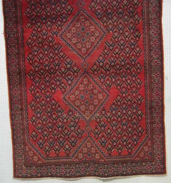 A contemporary Persian carpet with red ground and 28th July 2004