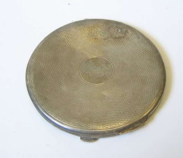 A lady's silver compact with engine turned decoration 24th August