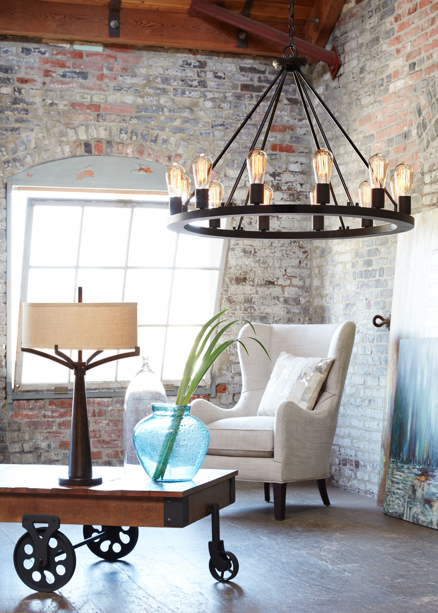 An industrial loft brightened by a large chandelier with Edison style
