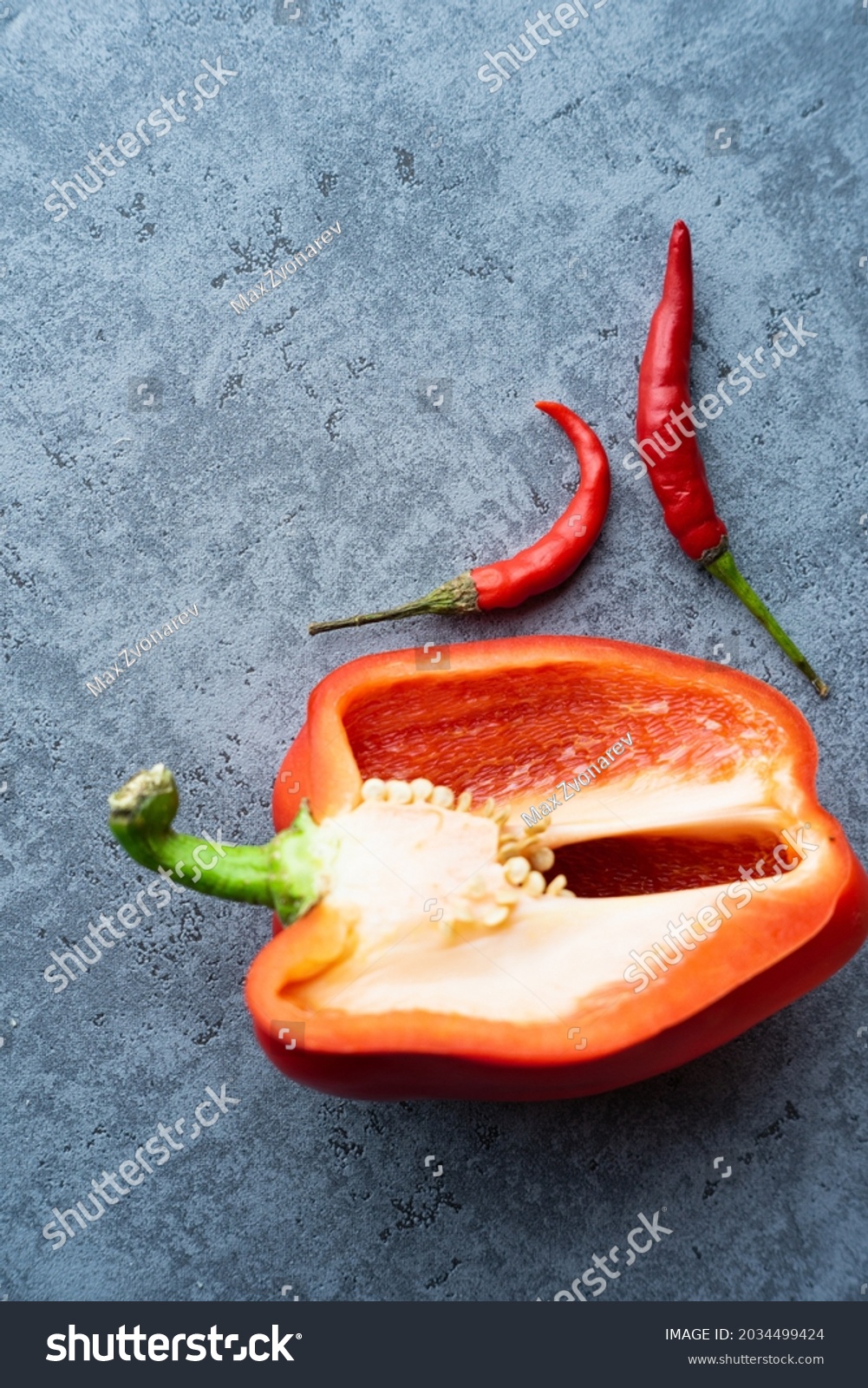 assorted chili peppers and half of red paprika Royalty Free Stock