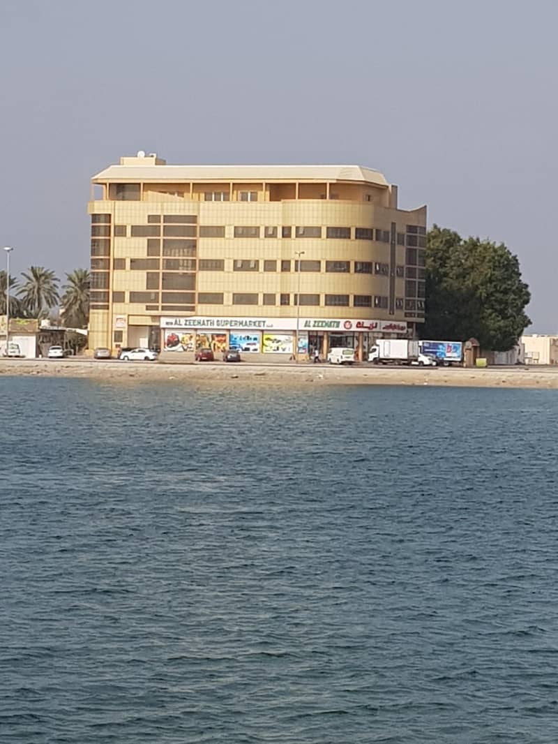 For rent in Umm Al Quwain a new building available 3 room + Hall , a