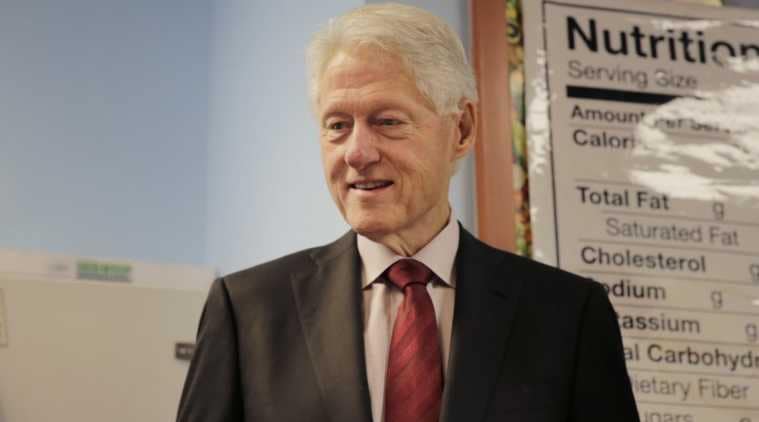 Former US President Clinton improving but will remain hospitalised