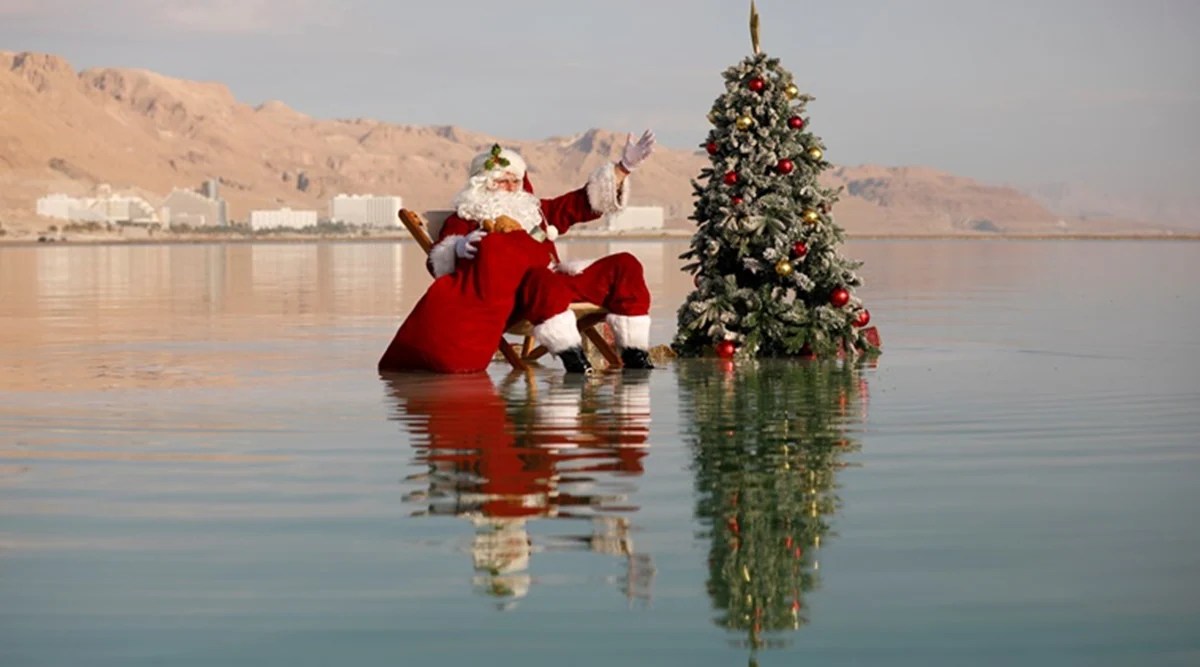 Man dresses as Santa Claus and takes dip in Dead Sea to spread