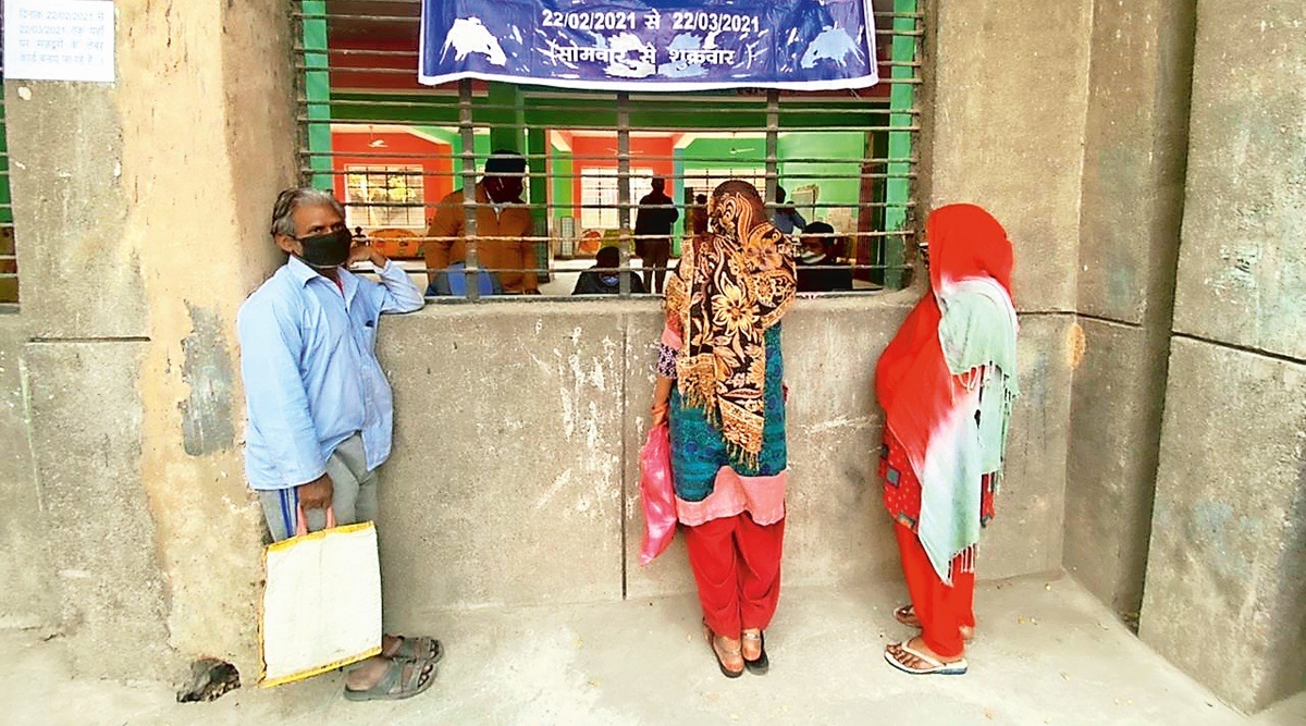 Delhi Construction workers queue up with forms, questions at