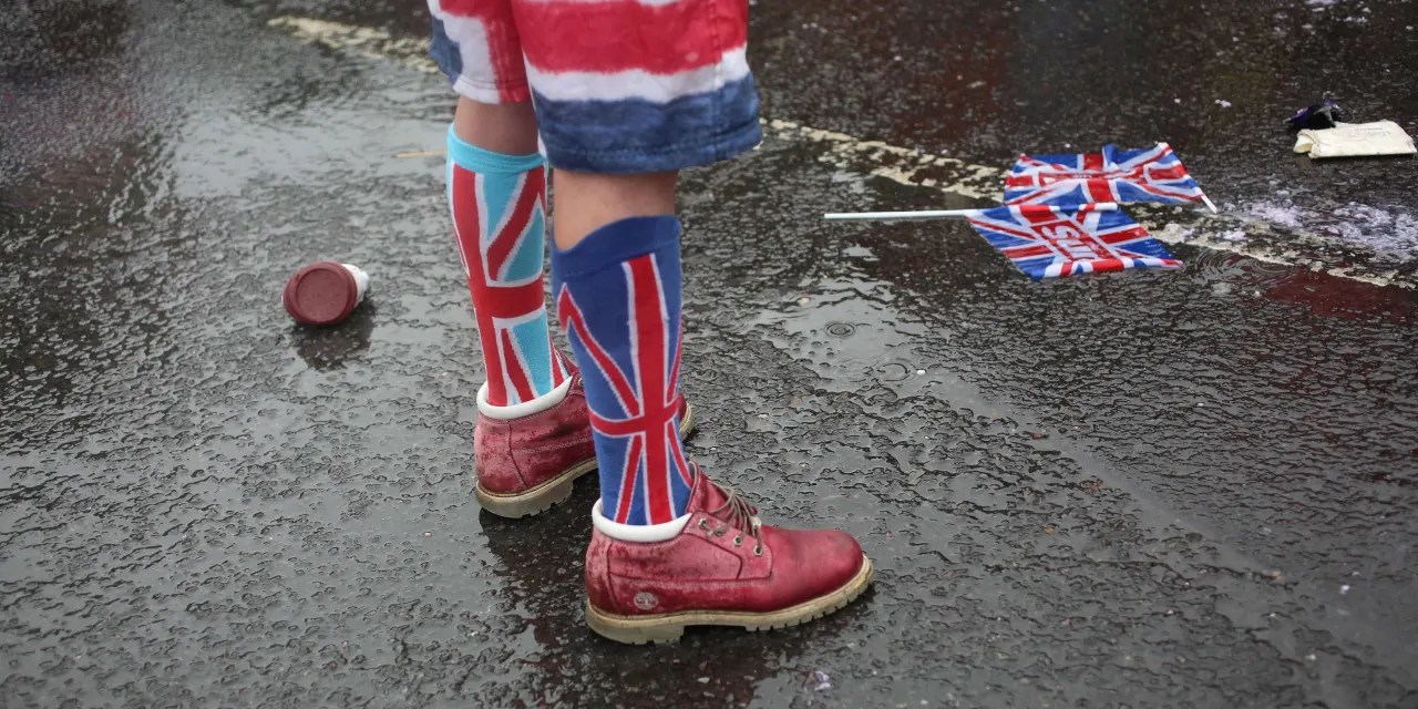 U.K. pound and bond yields fall after wet weather damps British economy