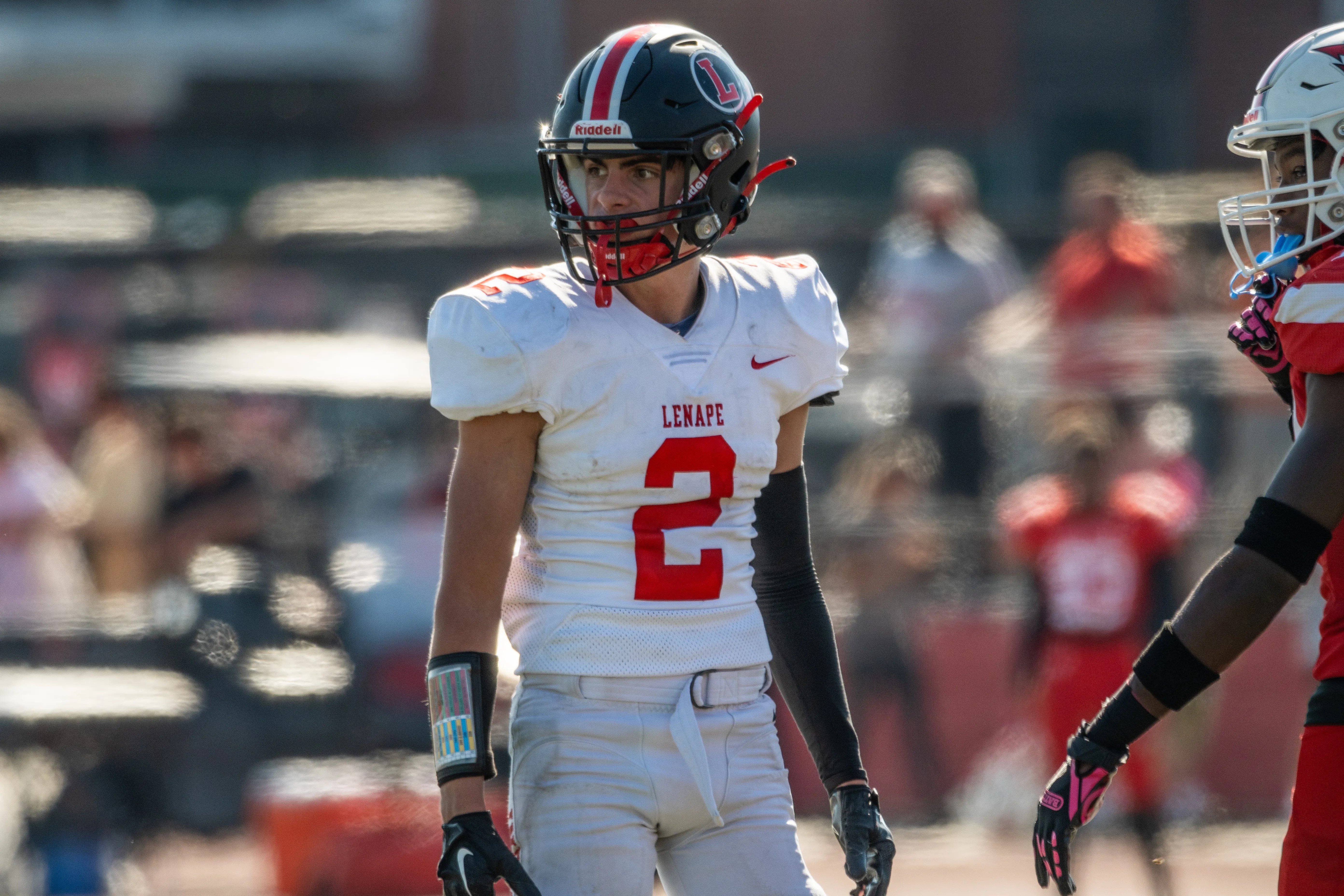 Dynamic portrait of an American football player in action during a game, showcasing athletic spirit.