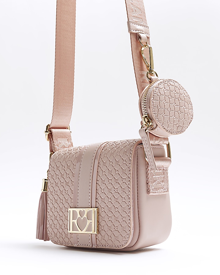 Girls pink embossed RI cross body bag River Island