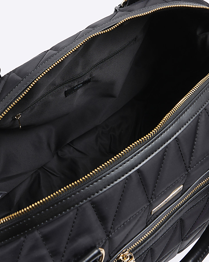 Black quilted zip travel bag River Island
