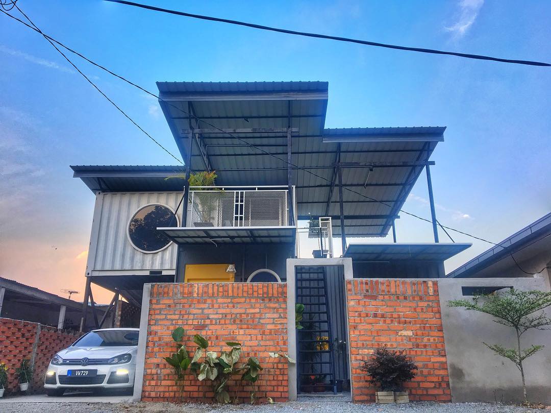 Malaysian Couple's Tiny Container Home Has A Spiral Staircase & 'Submarine' Windows