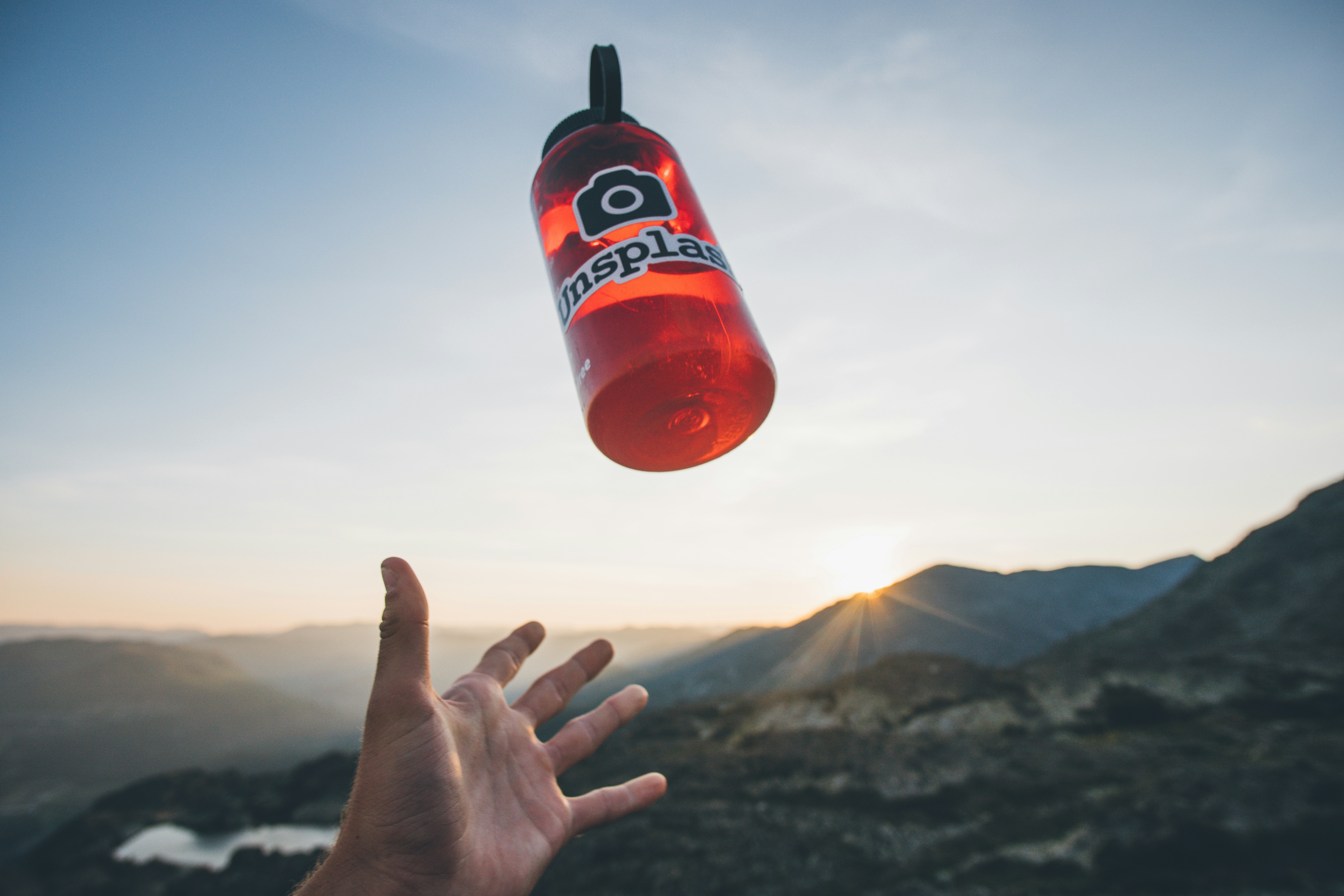 person throws away red water bottle photo Free Person Image on Unsplash