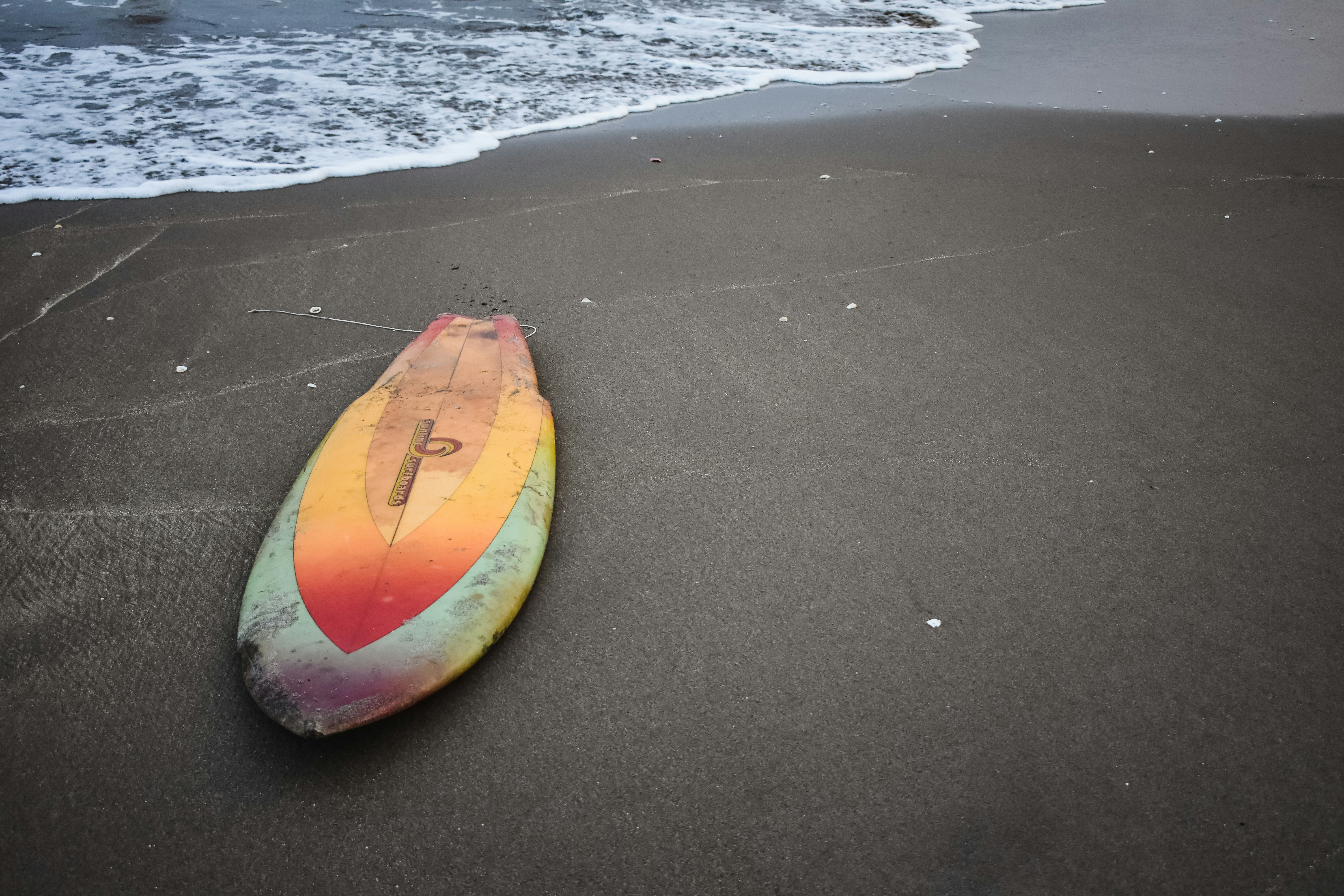 Gray and orange surfboard on seashoew photo Free El salvador Image on