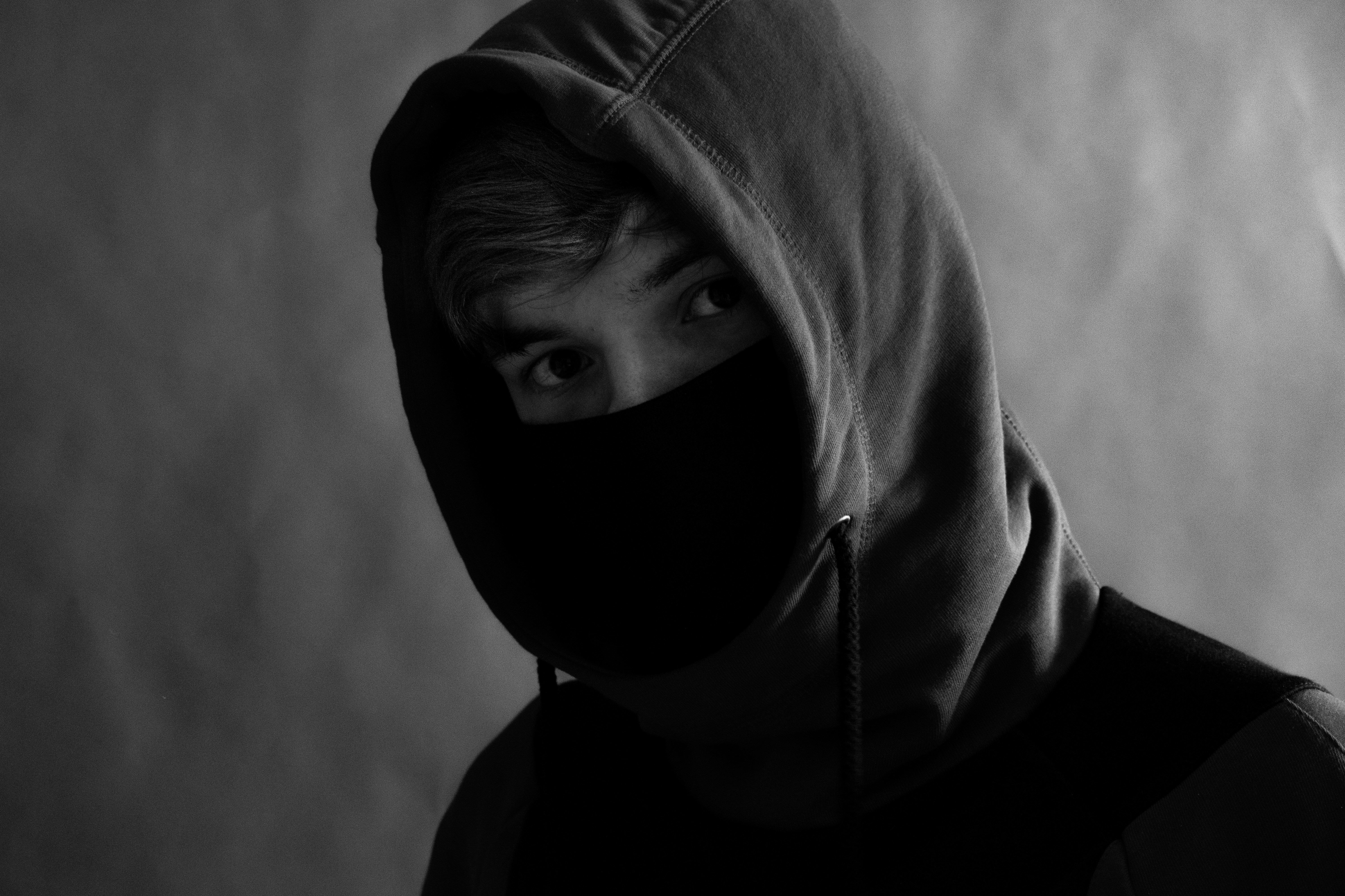 photo of person wearing hoodie and mask photo Free Black Image on