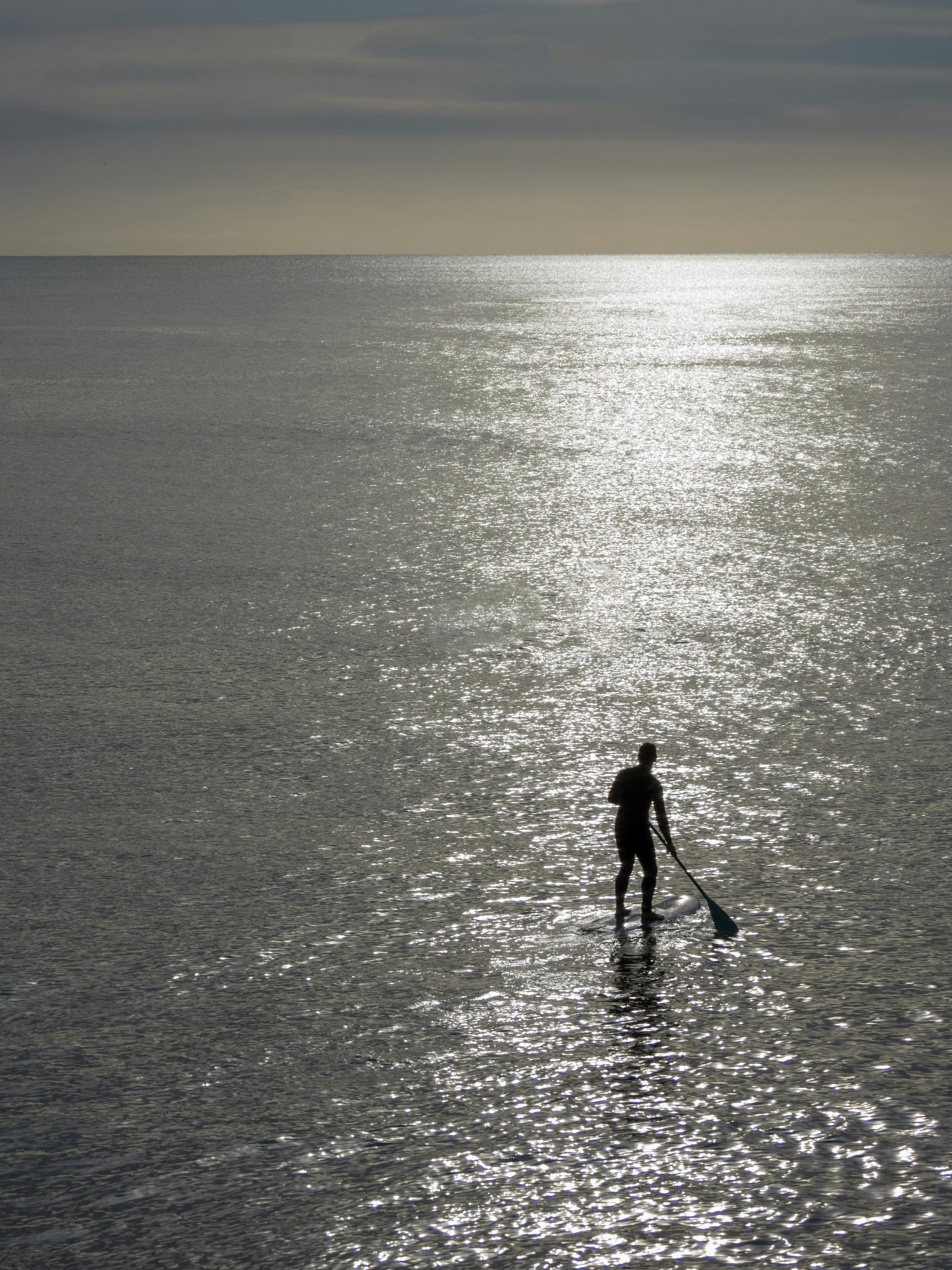 man standing in water photo Free Grey Image on Unsplash