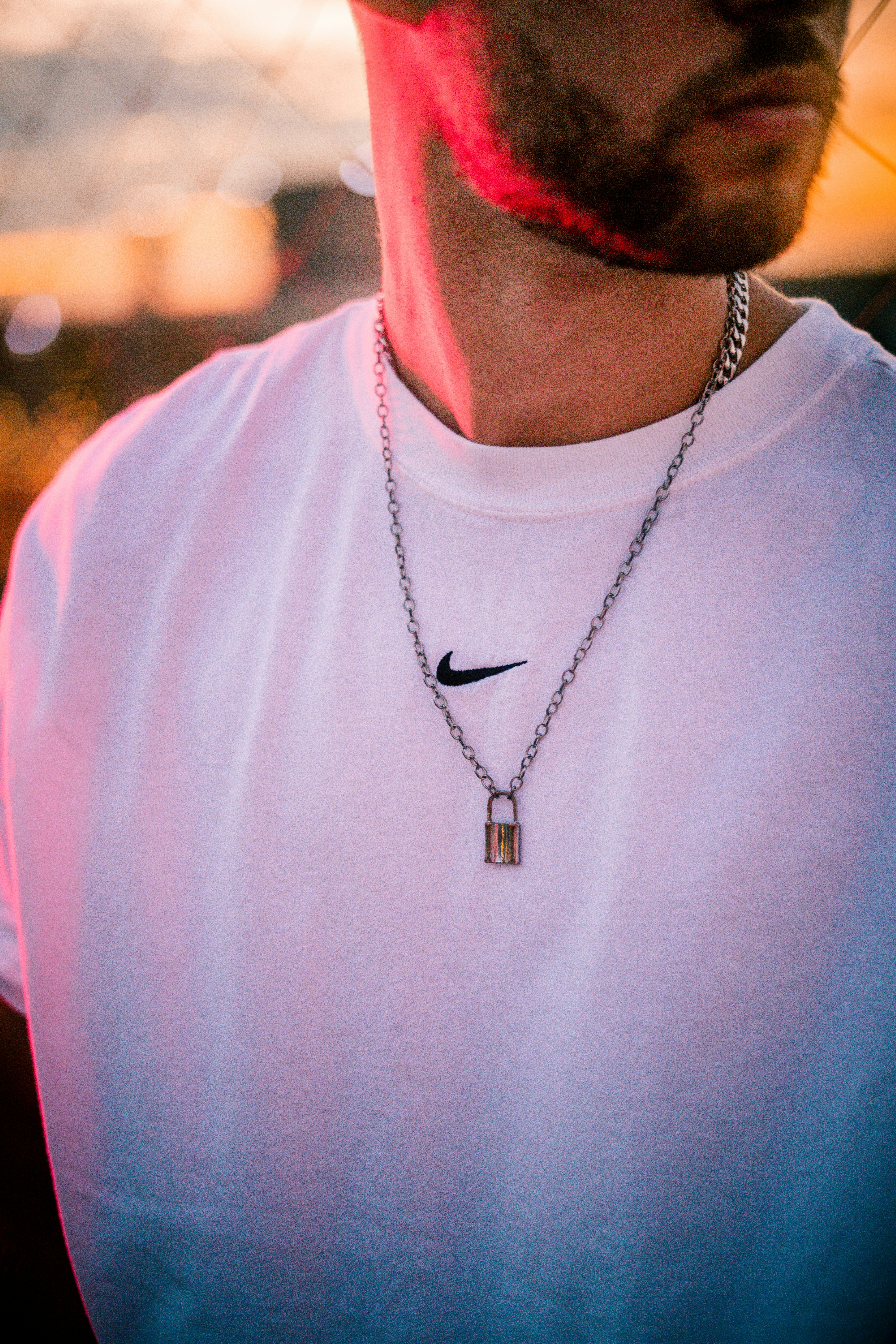 man in white crew neck shirt wearing silver necklace photo Free