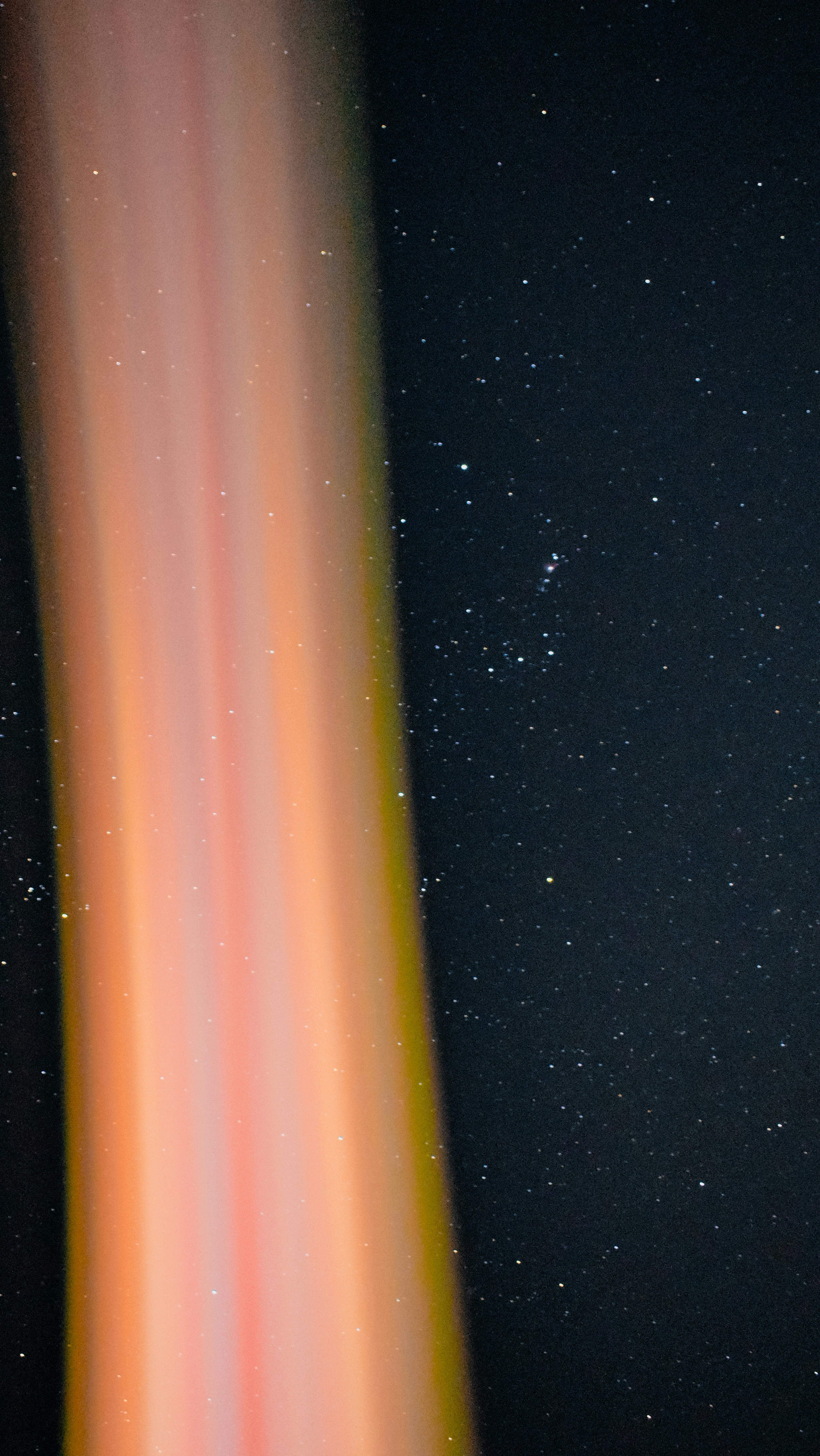 An orange and yellow streak in the night sky photo Free Night sky