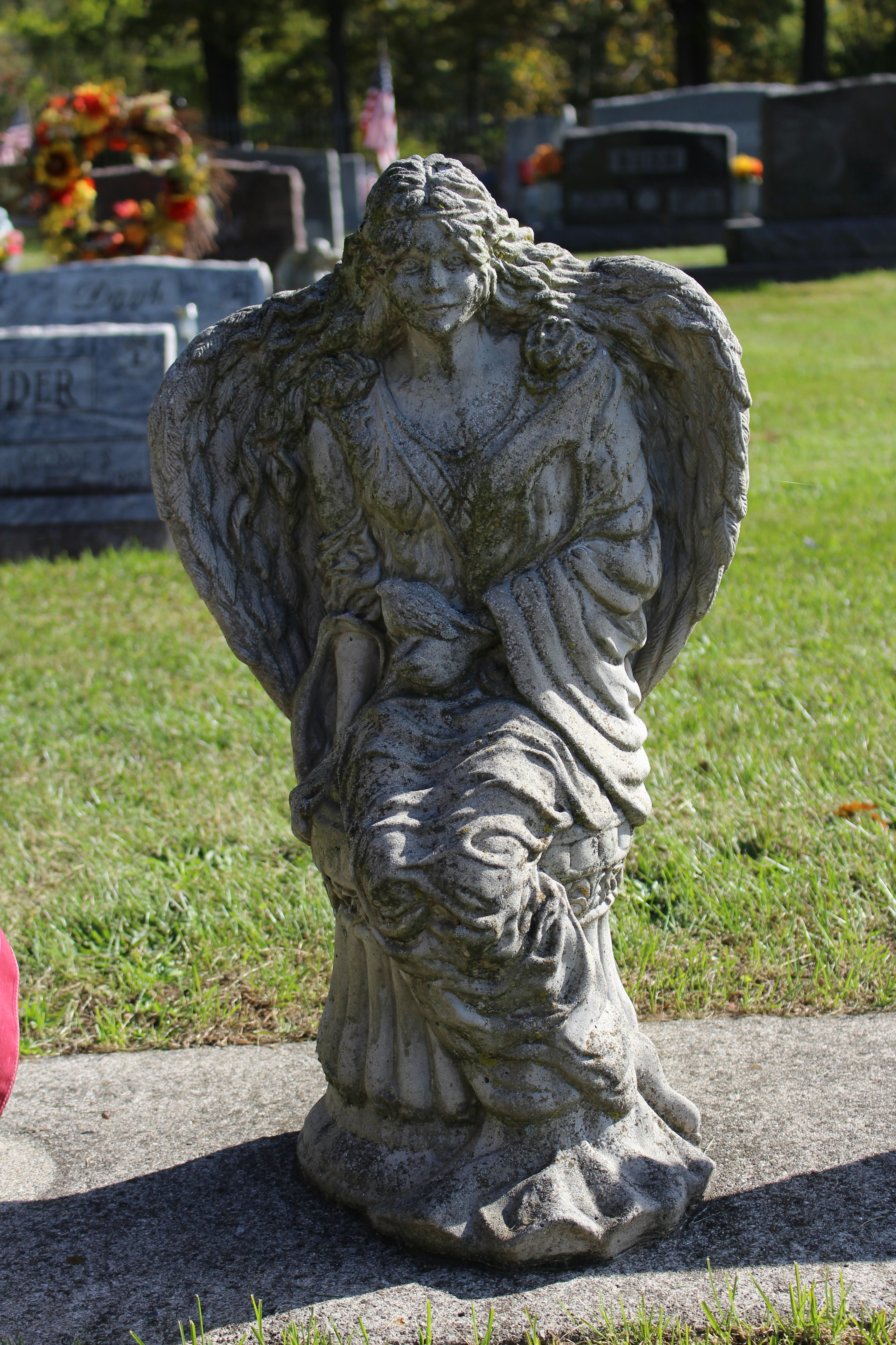 A statue of an angel in a cemetery photo Free Creepy angel statue