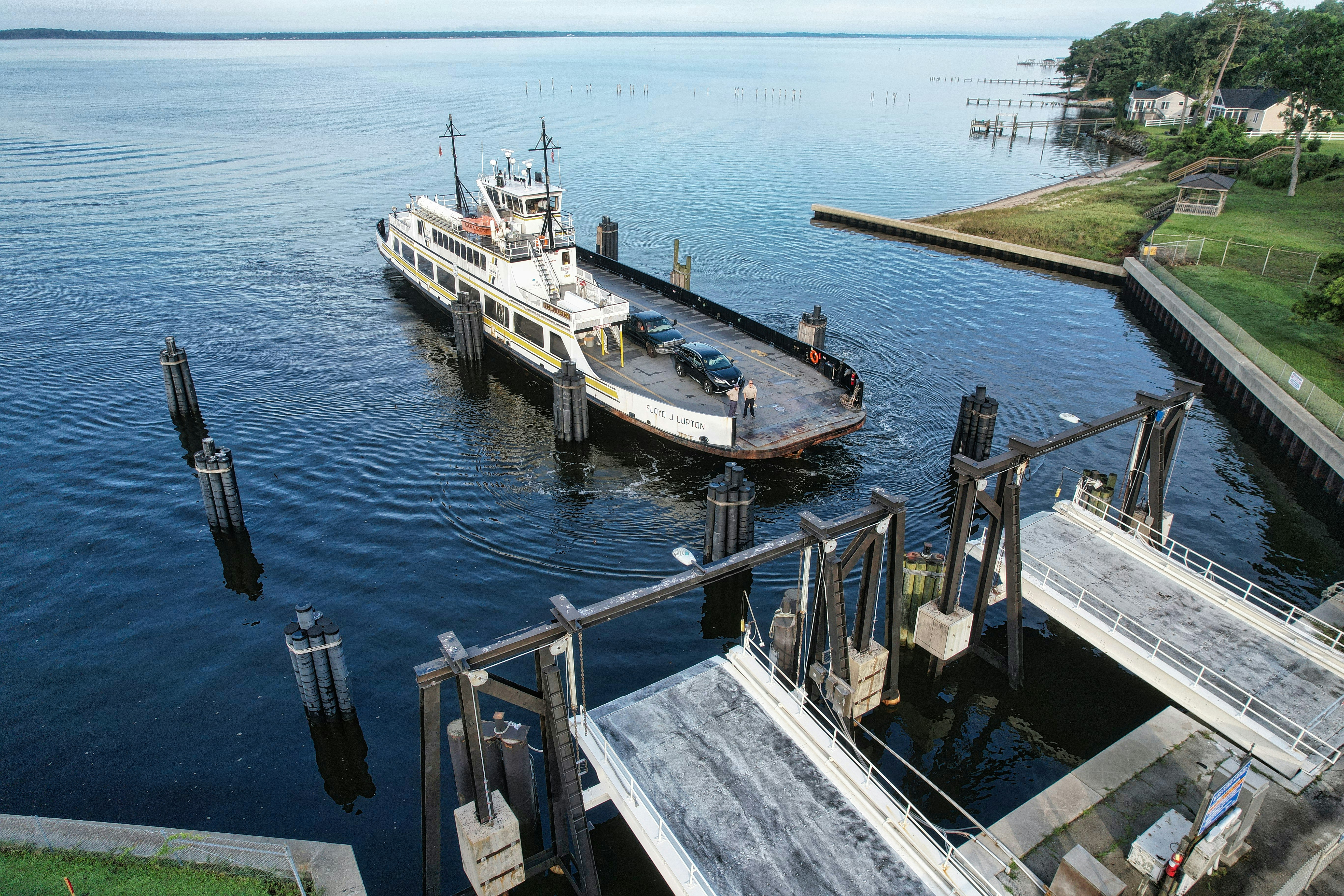 A boat is docked at a pier on the water photo Free Cherry branch