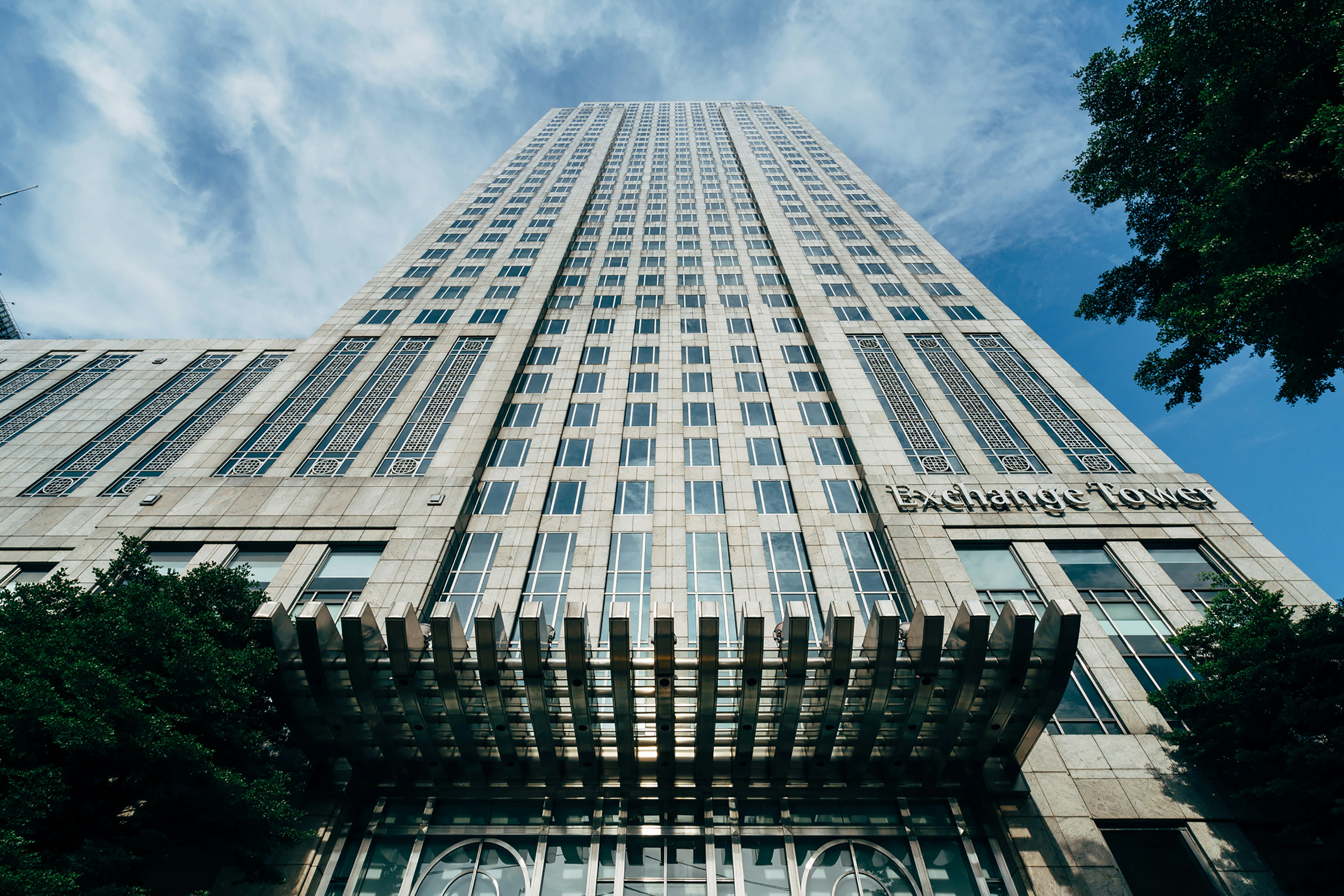 A very tall building with a sign on the side of it photo Free