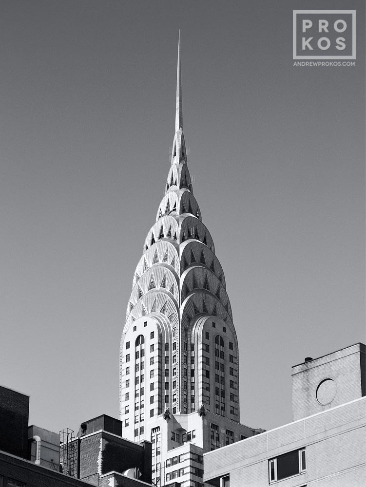 Chrysler Building Spire with Rooftops Framed Photograph by Andrew Prokos