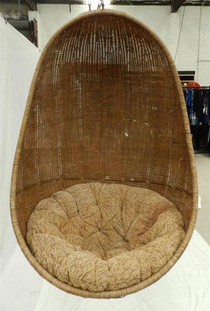 An outdoor wicker egg swing chair with upholstered cushion,… Seating