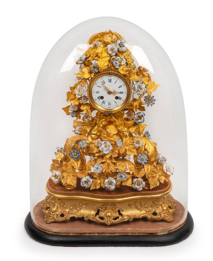 A stunning antique French mantle clock in glass dome, with… Clocks