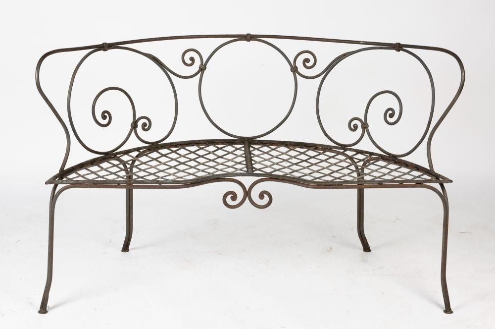 A wrought iron outdoor bench, the bow shaped tubular bench of