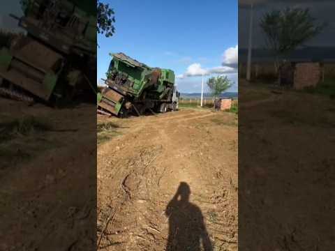 Tractor Overturns Giant Combine Harvester On Truck