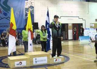 Ahuya Snowball Receiving A Bronze Ulu In One Foot High Kick Junior Male Category