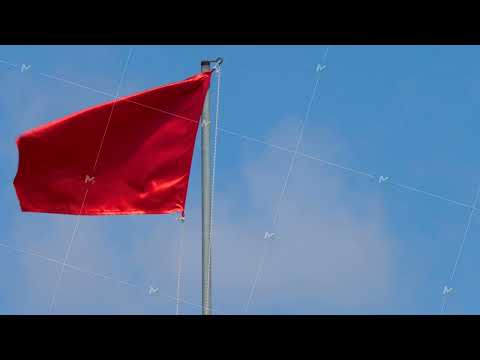 Red Flag Wave In Wind On Blue Sky Background Red Flag Wave In Wind On Blue Sky Background
