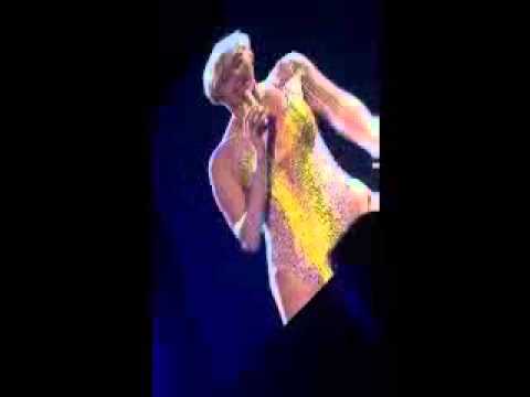 MILEY CYRUS WITH DILDO BETWEEN HER TITTS ON STAGE AND SPITTING AT FANS