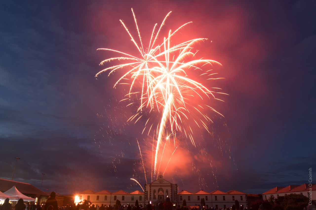 Fireworks in the sky above Spike Island with the barracks seen in the foreground.