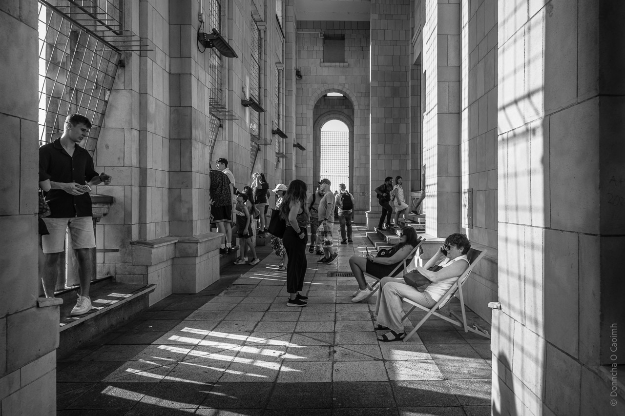 People on the 30th floor of the Palace of Culture and Science. Some sitting in deckchairs, other walking around or looking at the view