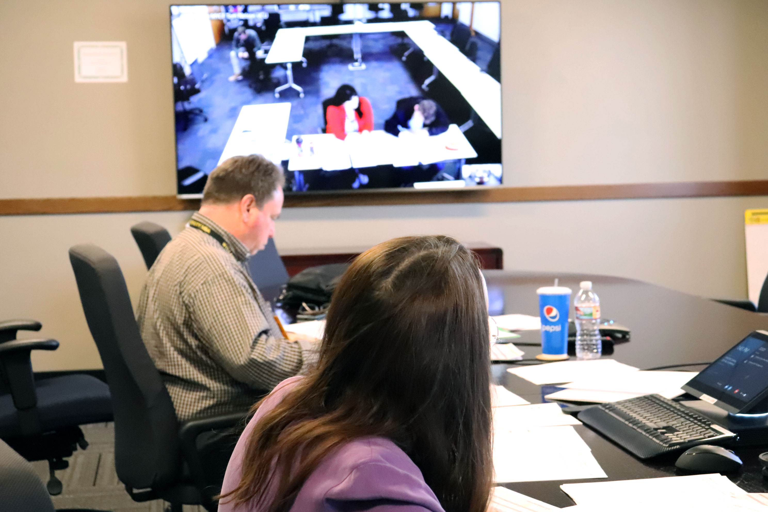 two Revenue employees meet via video with youth