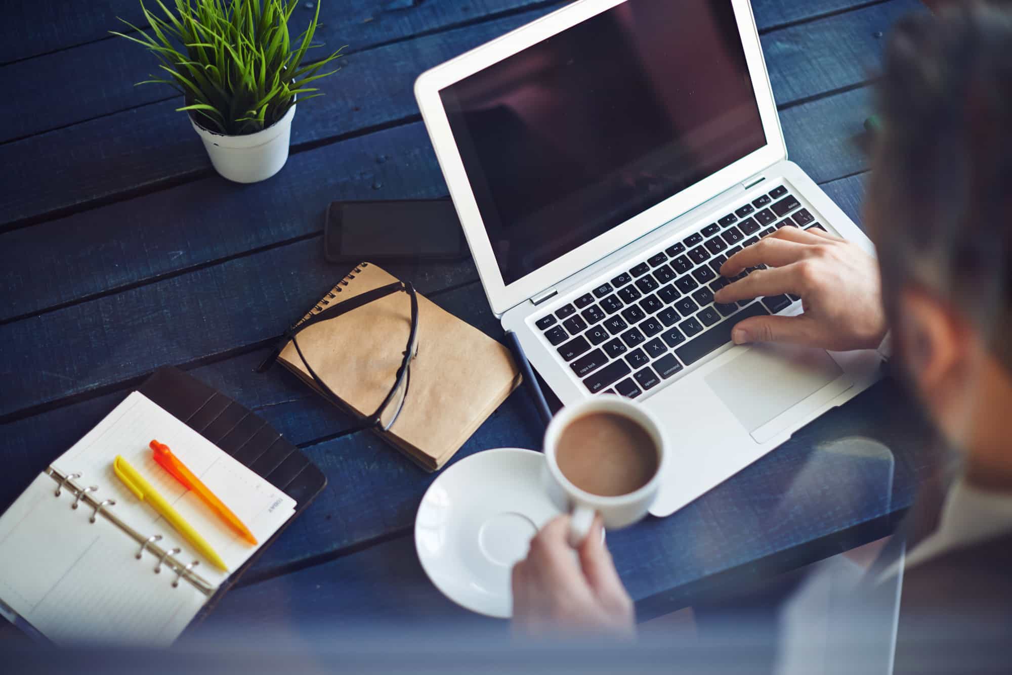 Businessman working with laptop at office table Integrity Investigations, LLC