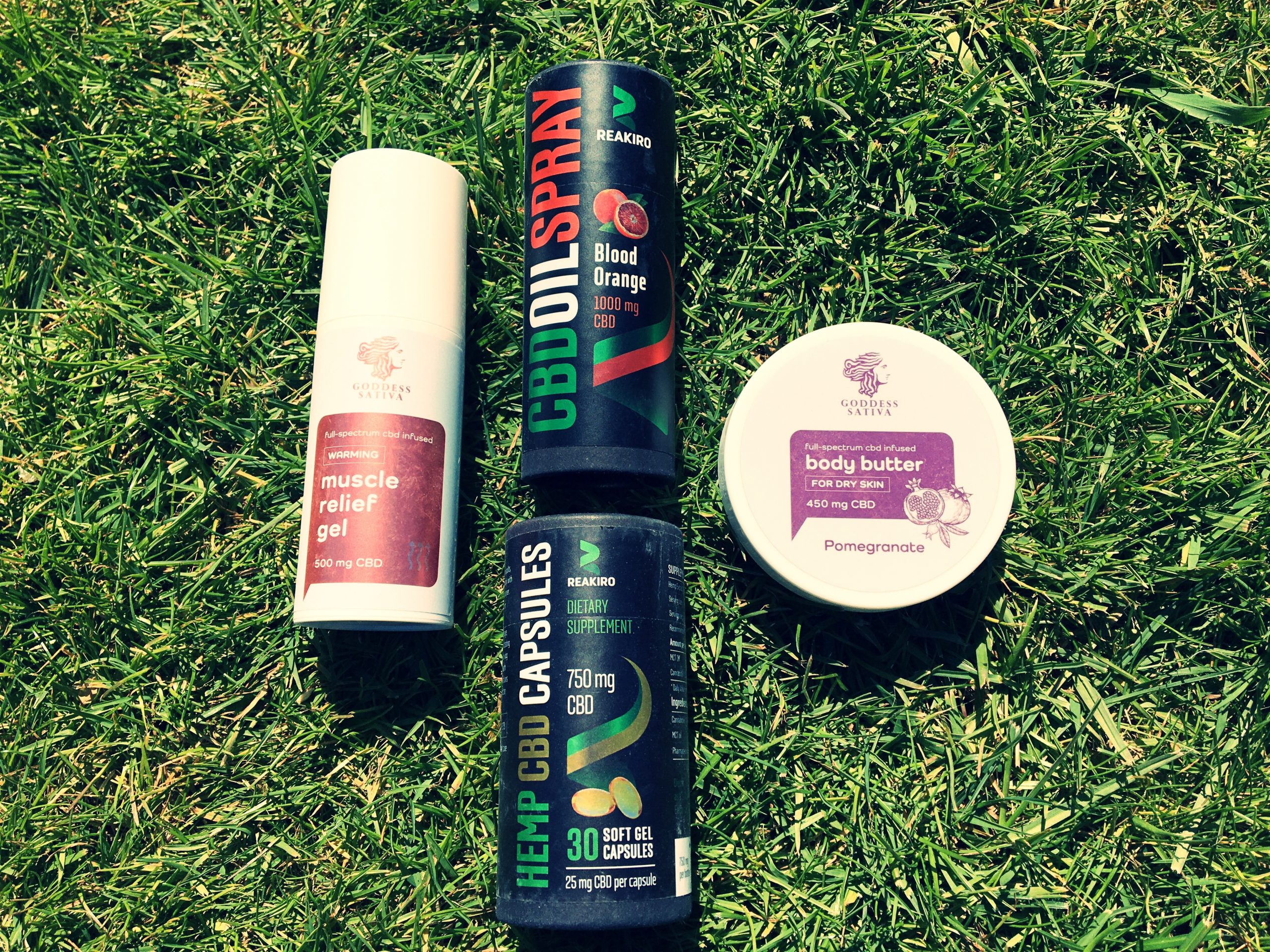 All four products laid next to each other on the grass.