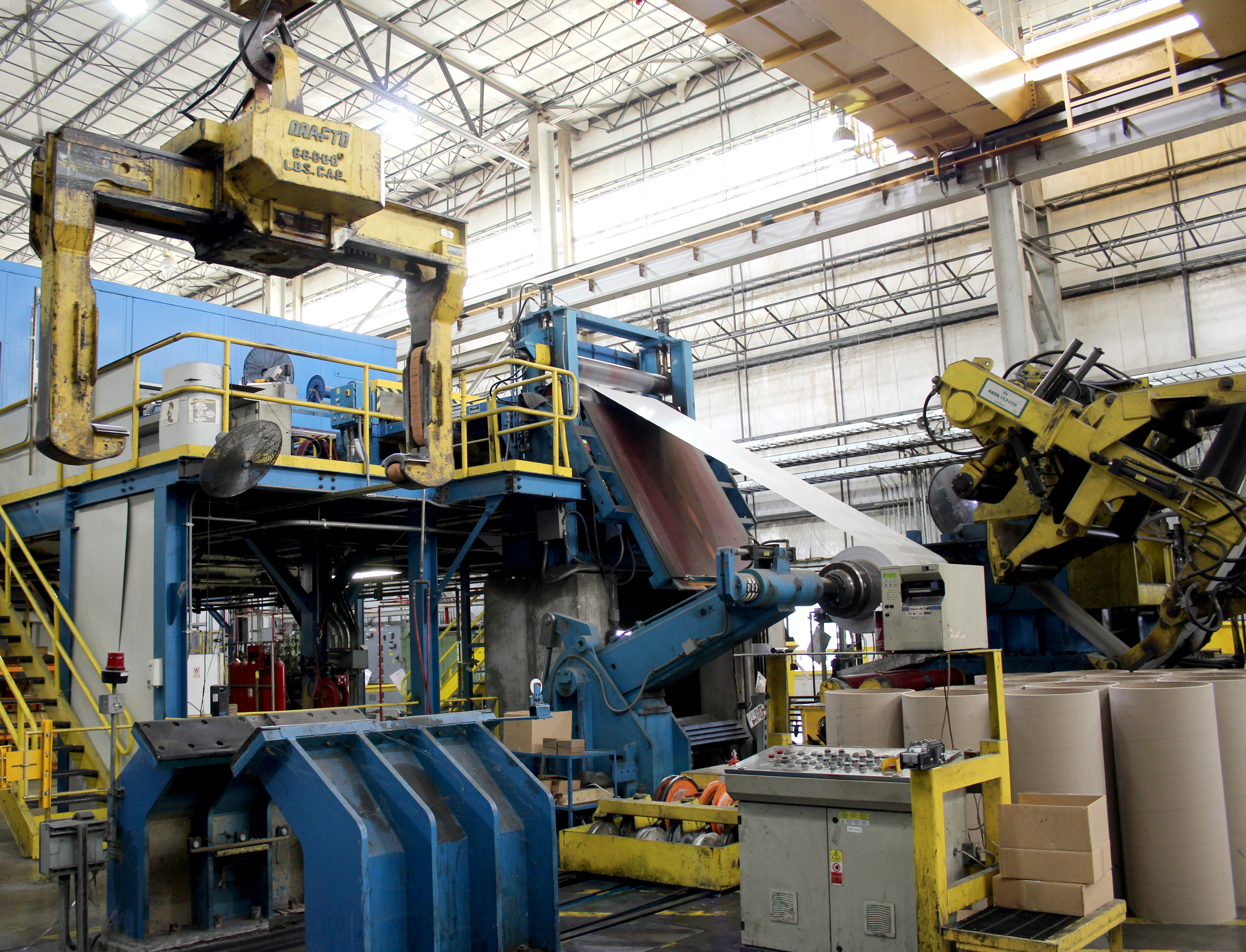 A Steel Dynamics worker watches over the automated zinc dipping process
