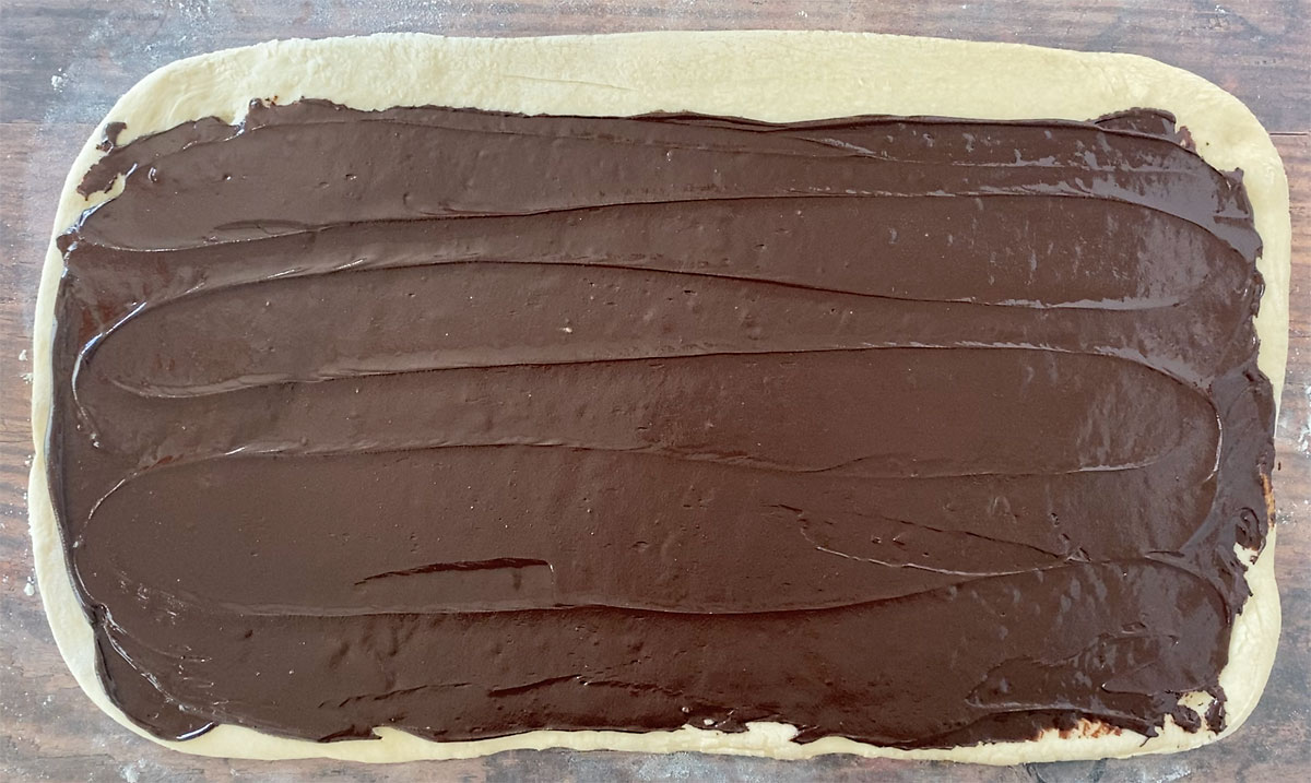 Rectangle of bread dough spread with chocolate babka filling