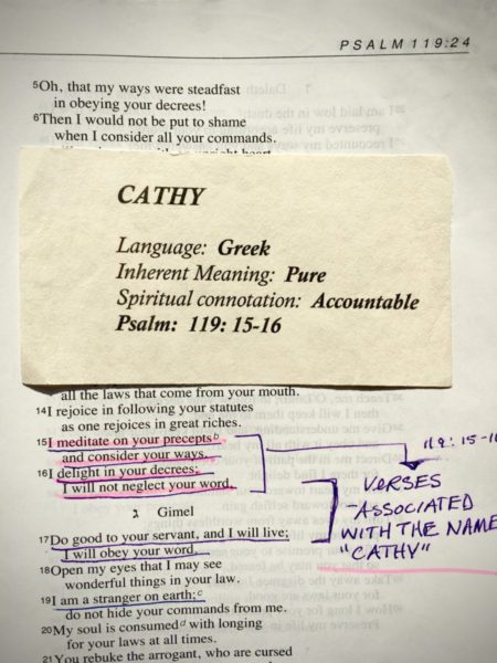 Used Book New Heart image of a marked up and highlighted bible and a card with the meaning of the name Cathy