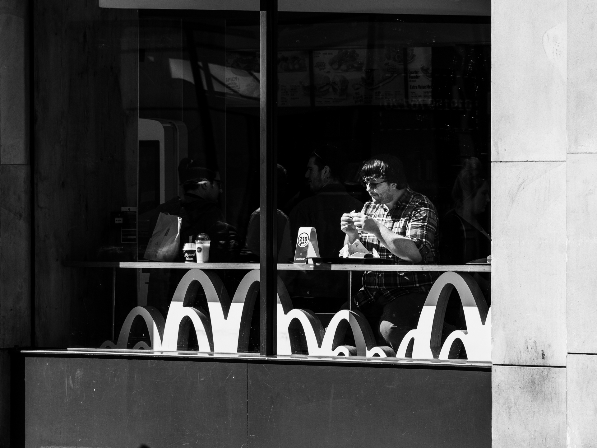 Man eating in a fast food outlet. This came to a stop during the Covid-19 crisis.