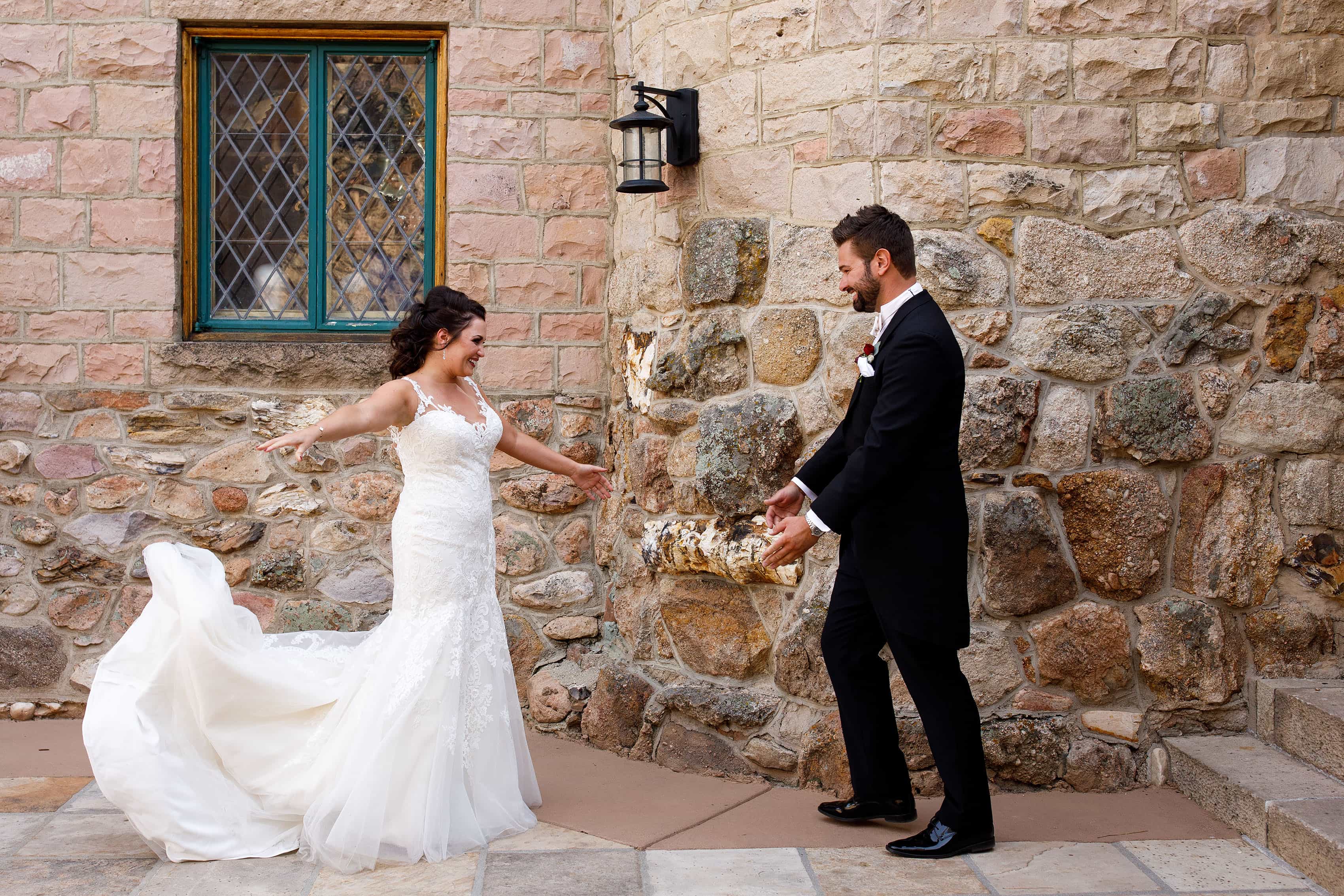 The bride and groom react during their first look before their wedding