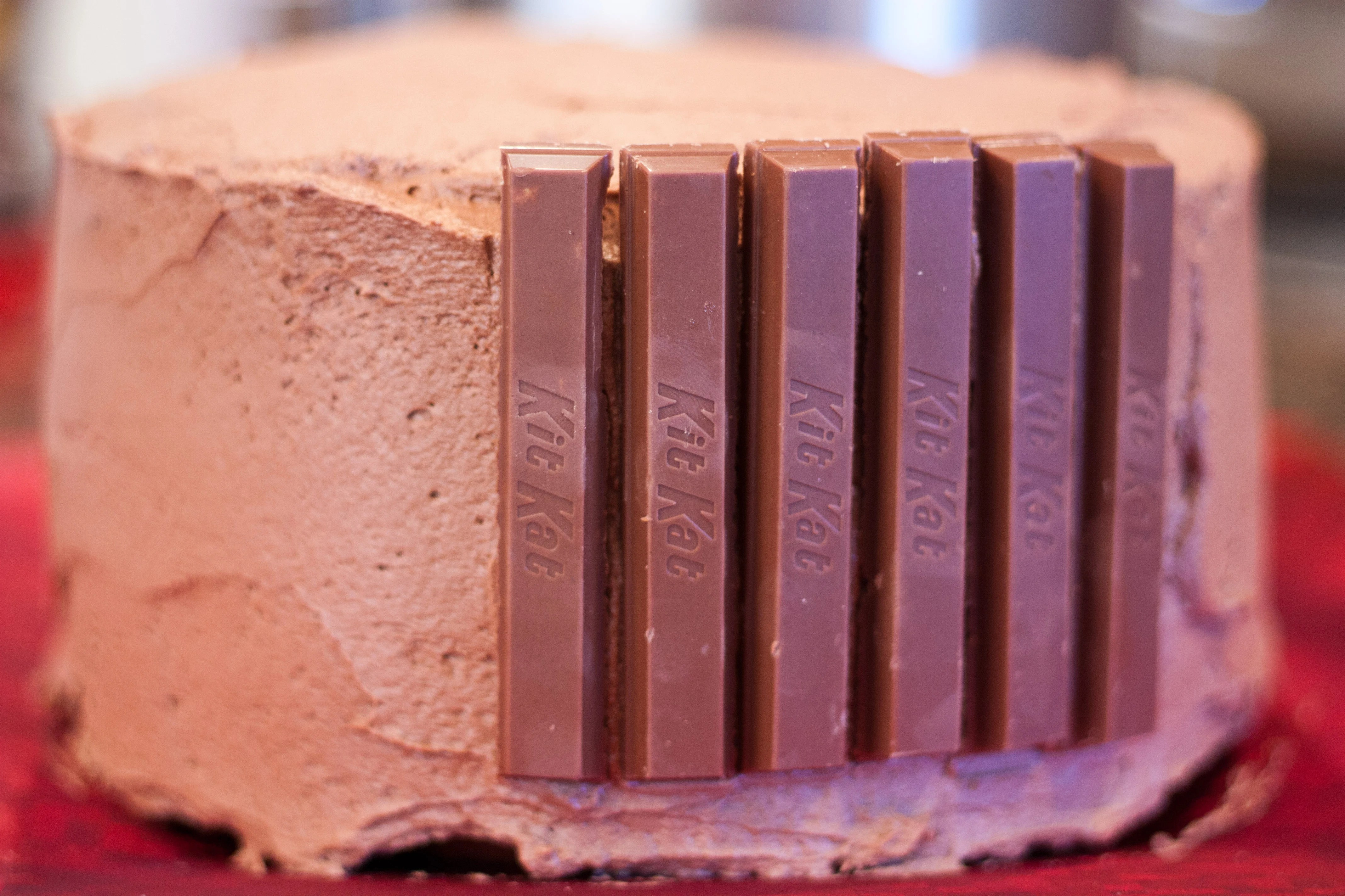 Working quickly, place kit kat bars side by side all around the edge