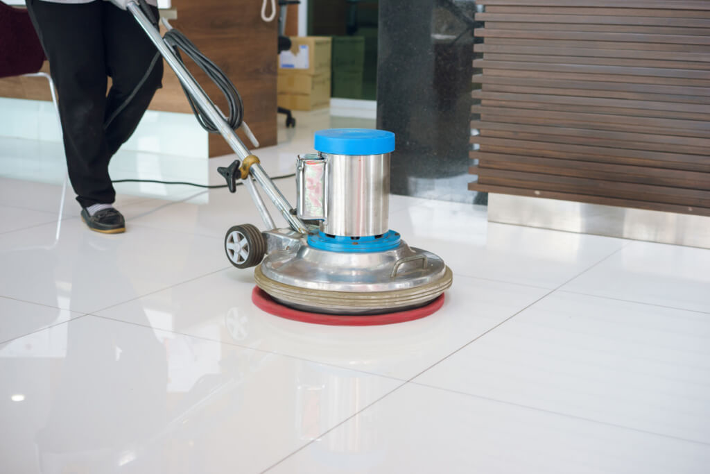 cleaning floor with machine. Jones Janitorial Service & Tiger Carpet