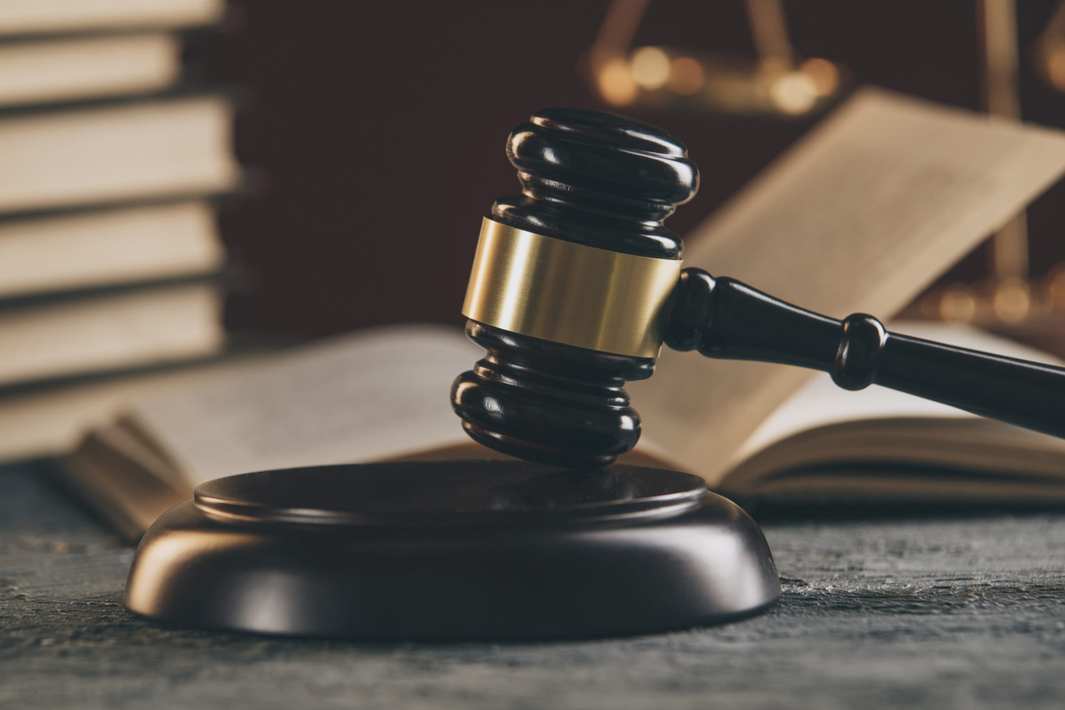 Law concept Open law book with a wooden judges gavel on