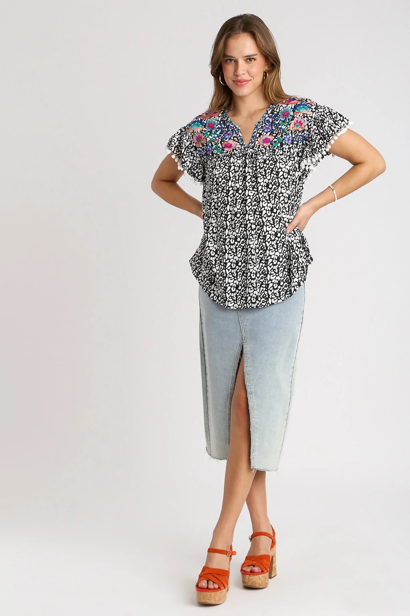 Umgee Animal Print Top with Flower Embroidery and Pom Pom Fringe Detai